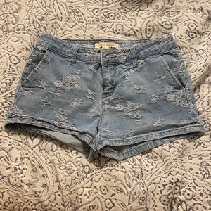 Denim shorts with white floral detailing